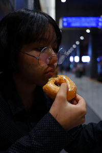 Close-up of teenage girl eating donut