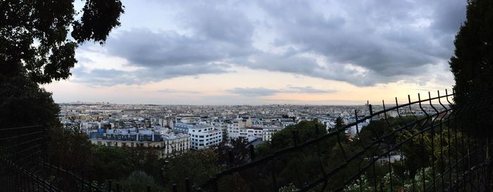 City buildings against cloudy sky