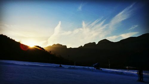 Scenic view of snow covered mountains against sky during sunset