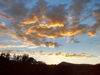 Scenic view of silhouette landscape against sky at sunset