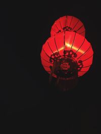 Low angle view of illuminated lights at night