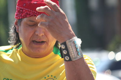 Midsection of man with bracelet and bandana on sunny day