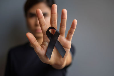 Close-up of human hand against black background