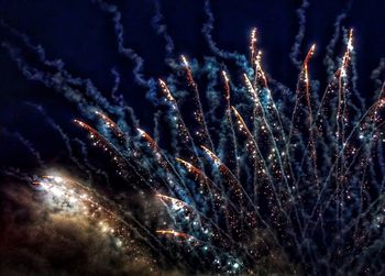 Low angle view of firework display at night