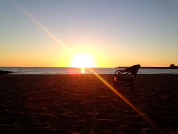 Scenic view of beach against sky during sunset