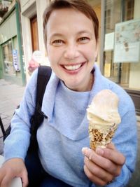 Portrait of smiling woman holding ice cream