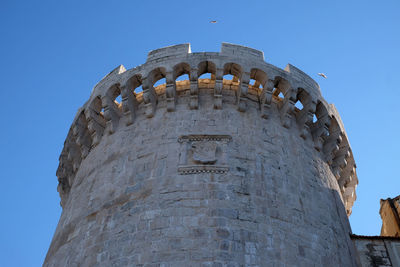 Low angle view of old building against blue sky