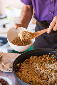Midsection of man preparing food