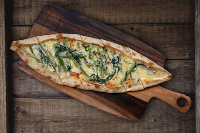 High angle view of pizza on cutting board