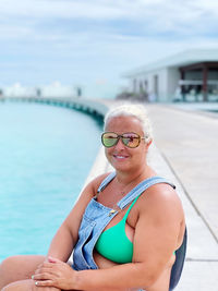 Portrait of a smiling young woman in swimming pool