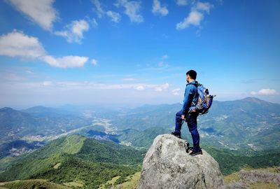 Man standing on mountain against sky