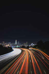 Light trails on road in city at night