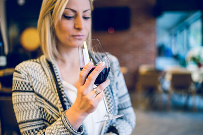 Close-up of woman drinking wine