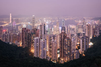 Hong kong urban skyline with high skyscrapers during moody dusk.