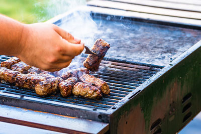 Cropped hand of person preparing food