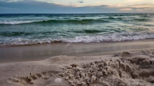 Scenic view of beach against sky during sunset