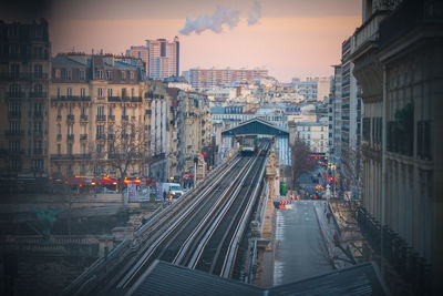 High angle view of railroad tracks amidst buildings in city