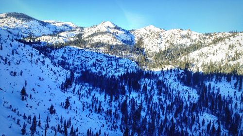 Scenic view of mountains against blue sky