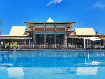 View of swimming pool building against blue sky