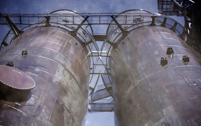 Low angle view of industry against sky