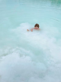 High angle view of boy swimming in pool