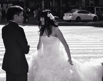Woman standing on city street