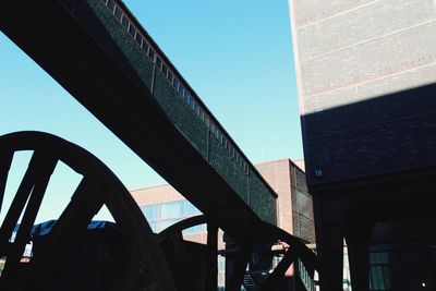 Low angle view of bridge against sky in city