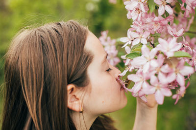 Portrait of woman with pink flowers