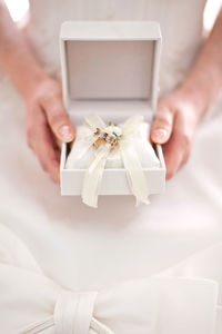 Midsection of woman holding wedding rings box