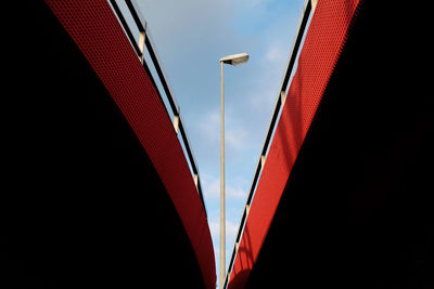 Low angle view of street light and buildings against sky