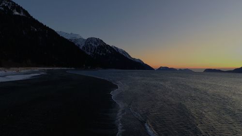 Scenic view of sea against clear sky during sunset