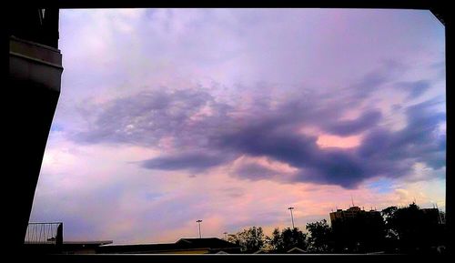 Low angle view of building against cloudy sky