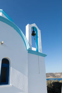 Low angle view of bell tower against blue sky