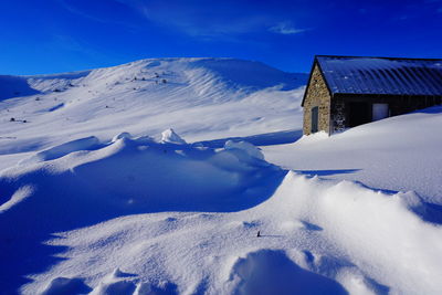 Scenic view of snowcapped mountain against sky during winter