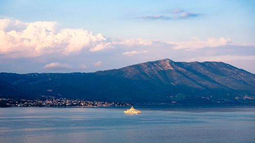 Scenic view of sea and mountains against sky