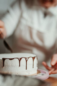 Midsection of woman holding cake