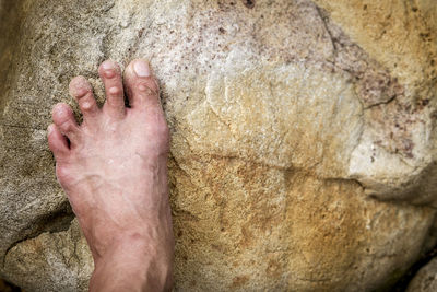 Low section of man standing on rock