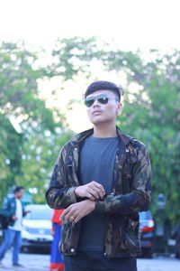 Young man wearing sunglasses standing outdoors