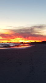 Scenic view of beach against sky during sunset