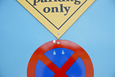 Close-up of arrow sign on road