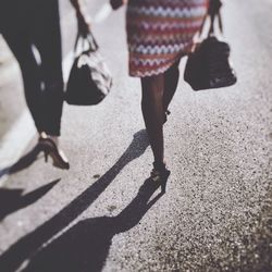 Low section of people standing on tiled floor