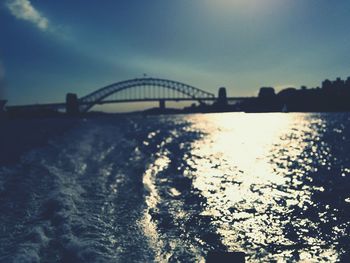 Bridge over river at sunset