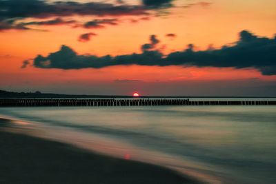 Scenic view of sea against orange sky