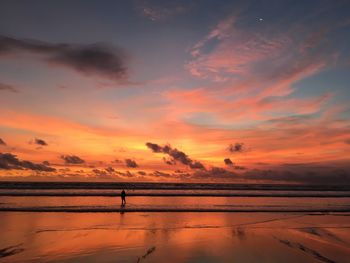 Scenic view of sea against orange sky