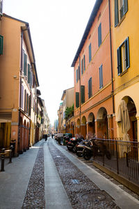 Street amidst buildings against sky