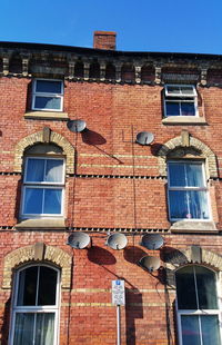 Low angle view of building against clear blue sky