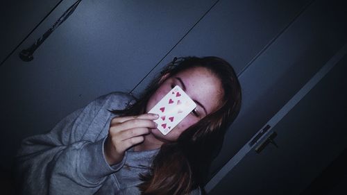 High angle portrait of girl holding mobile phone