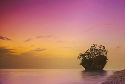 Scenic view of sea against sky at sunset