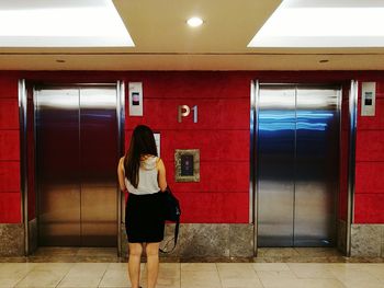 Full length of woman standing in corridor