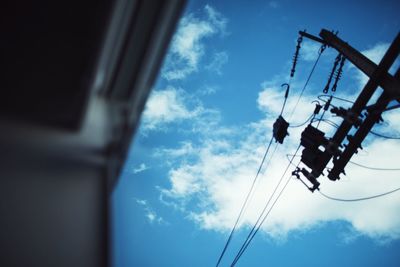 Low angle view of telephone pole against sky